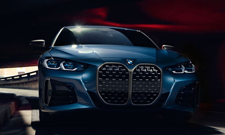 A BMW 4 Series Coupe driving through a tunnel.